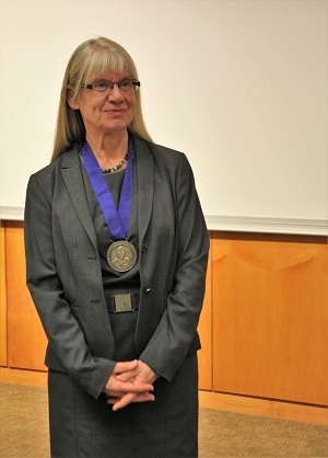 Dr. Gabriele Ludewig poses with award
