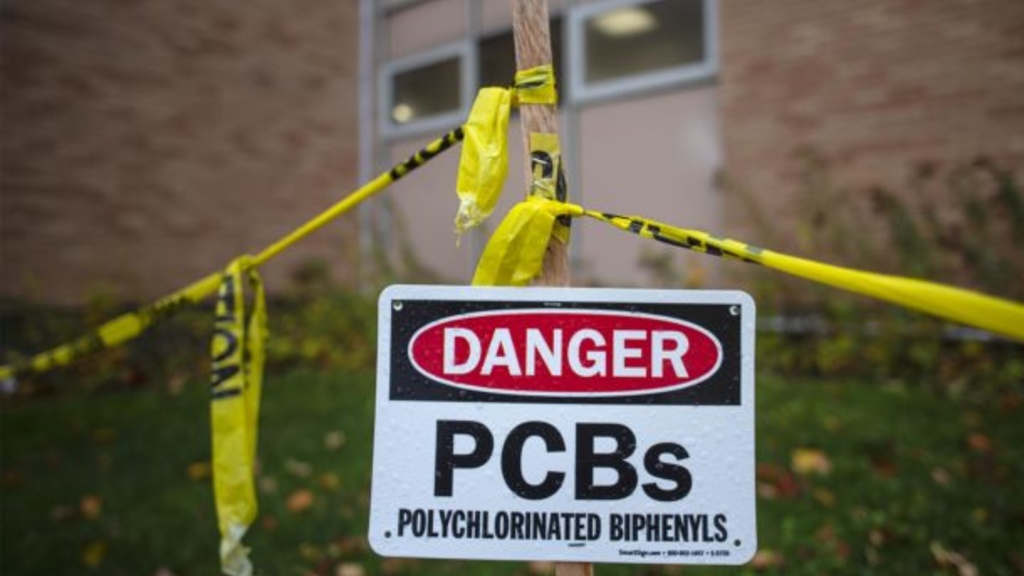 A PCB danger sign in front of Burlington High School